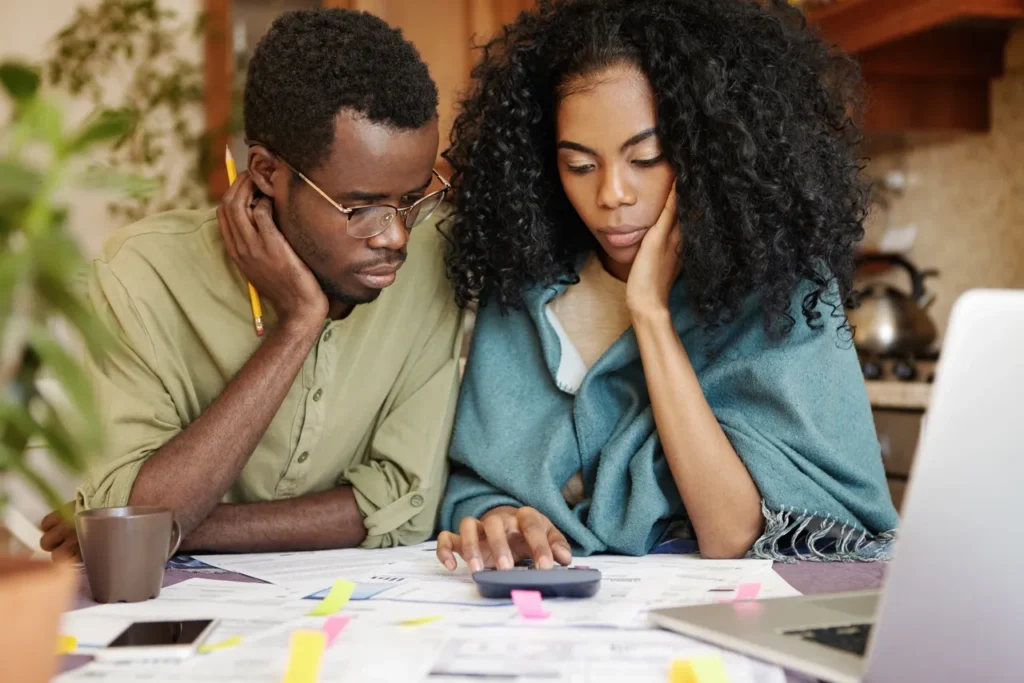 A man and woman looking at papers on the table