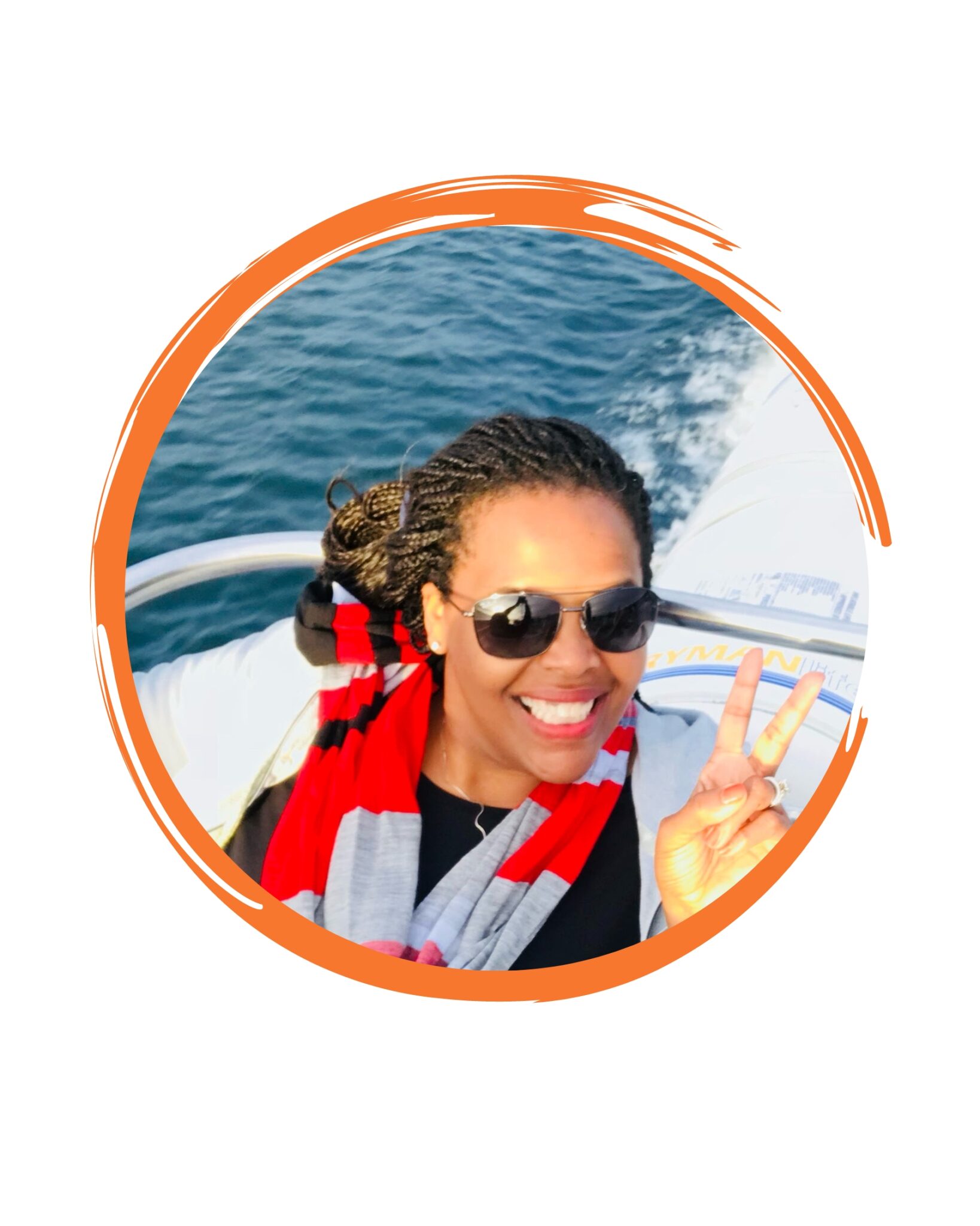 A woman in sunglasses and a red scarf on the boat.