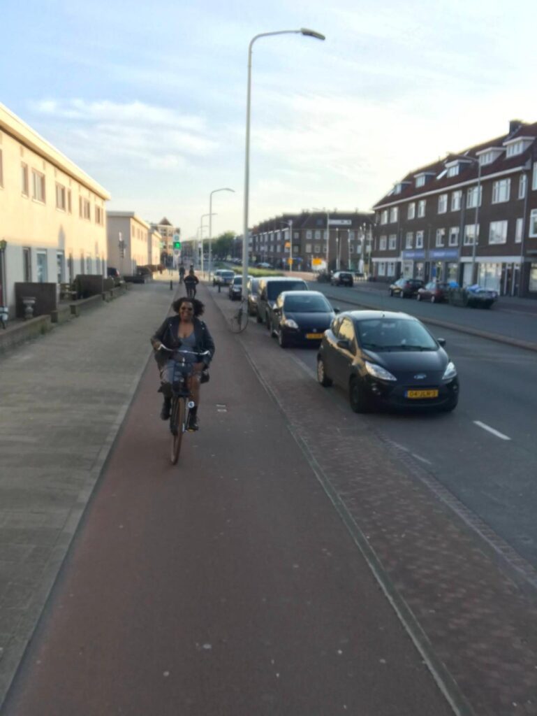 A person riding on the back of a bicycle.