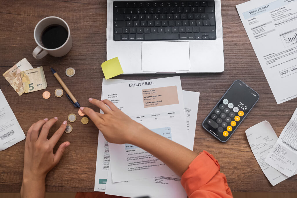 A person is working on their finances at the table.