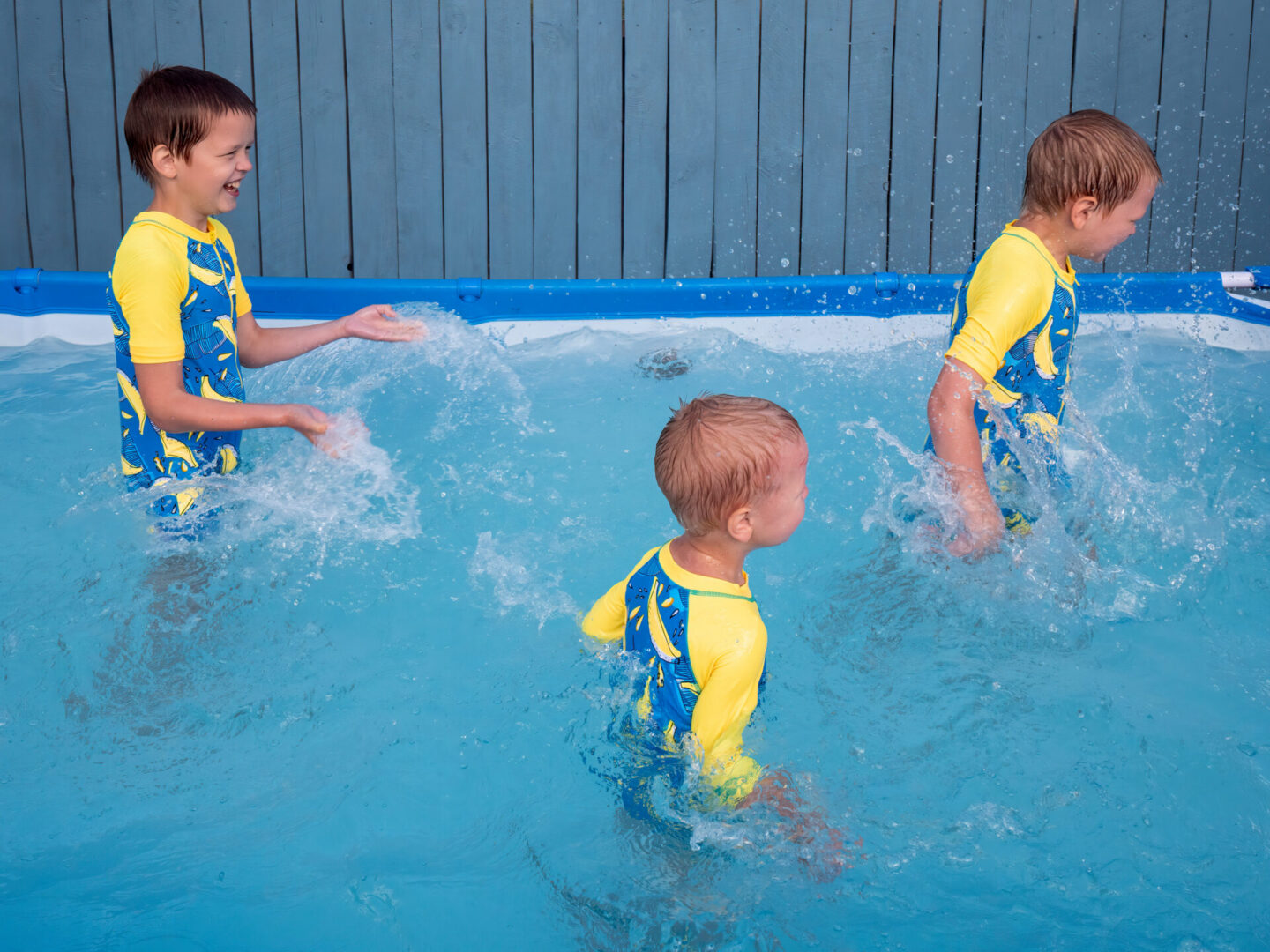 three-happy-kids-playing-in-carcas-pool-in-swimwea-2026-01-11-08-54-00-utc