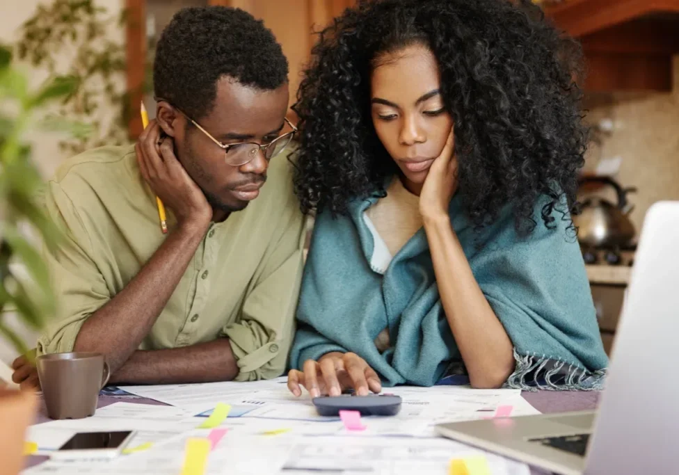 A man and woman looking at papers on the table