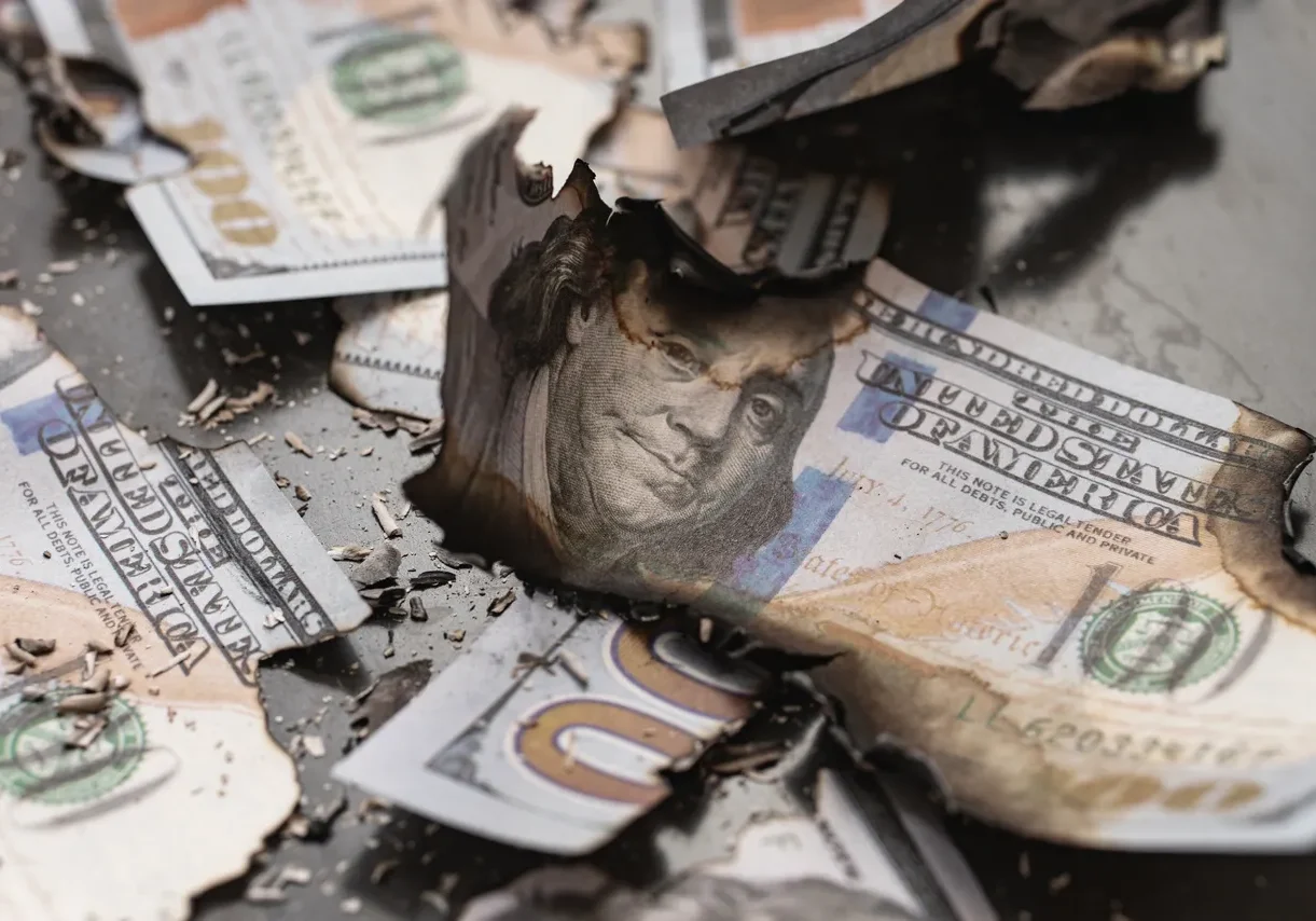 3 A pile of money that is broken up in half.